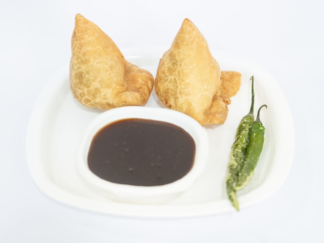 Golden fried aubergine fritters on a white plate