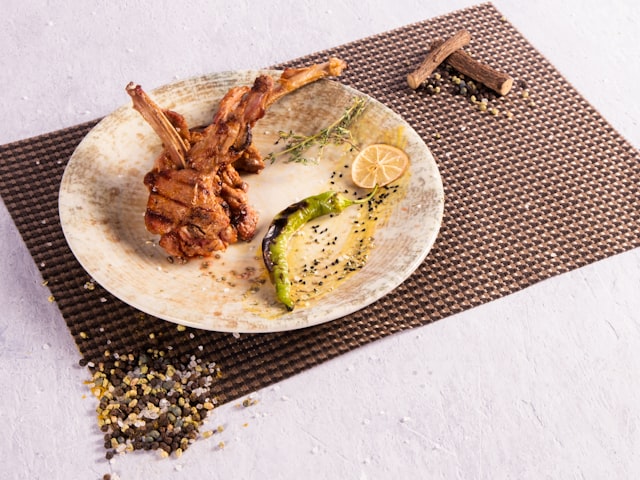 White plate with braised meat and vegetables