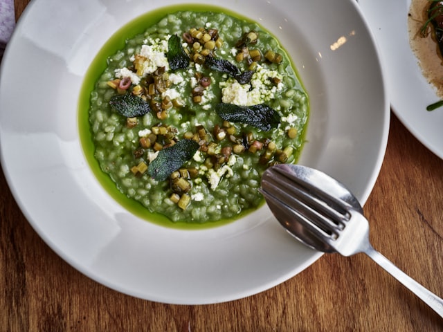 Green herb risotto with shaved cheese