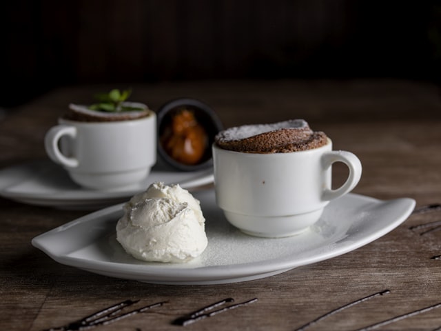 Two chocolate soufflés with ice cream and sauce