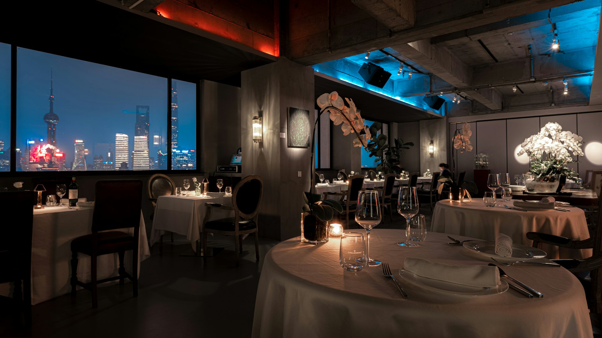 Candlelit dining room at Saffron & Ember overlooking the Dhaka skyline